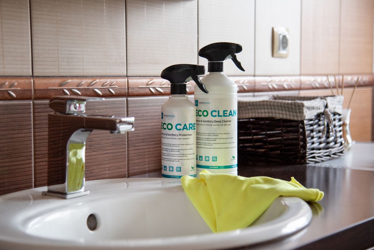 core-values Eco-friendly cleaning products displayed on a bathroom sink with tiles and a basket.